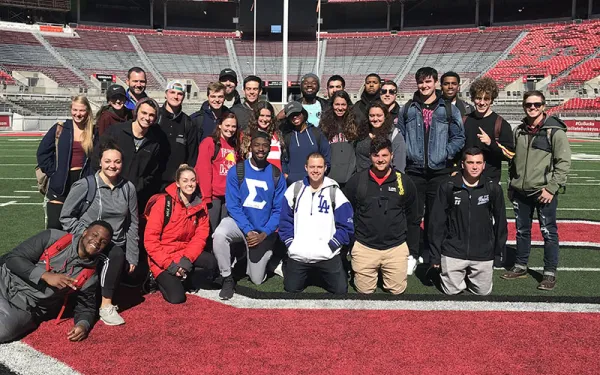 Students posing on the Ohio Stadium field